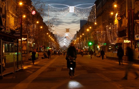 A cyclist makes her way along a pedestrian street lit with Christmas decorations in central Brussels at dusk on Monday, Nov. 23, 2015. Three days of the highest terror alert and unprecedented measures that have closed down the city's subways, schools and main stores, has created a very different atmosphere as the Belgian capital tries to avoid attacks similar to the ones that caused devastating carnage in Paris. (AP Photo/Alastair Grant) ORG XMIT: XAG111